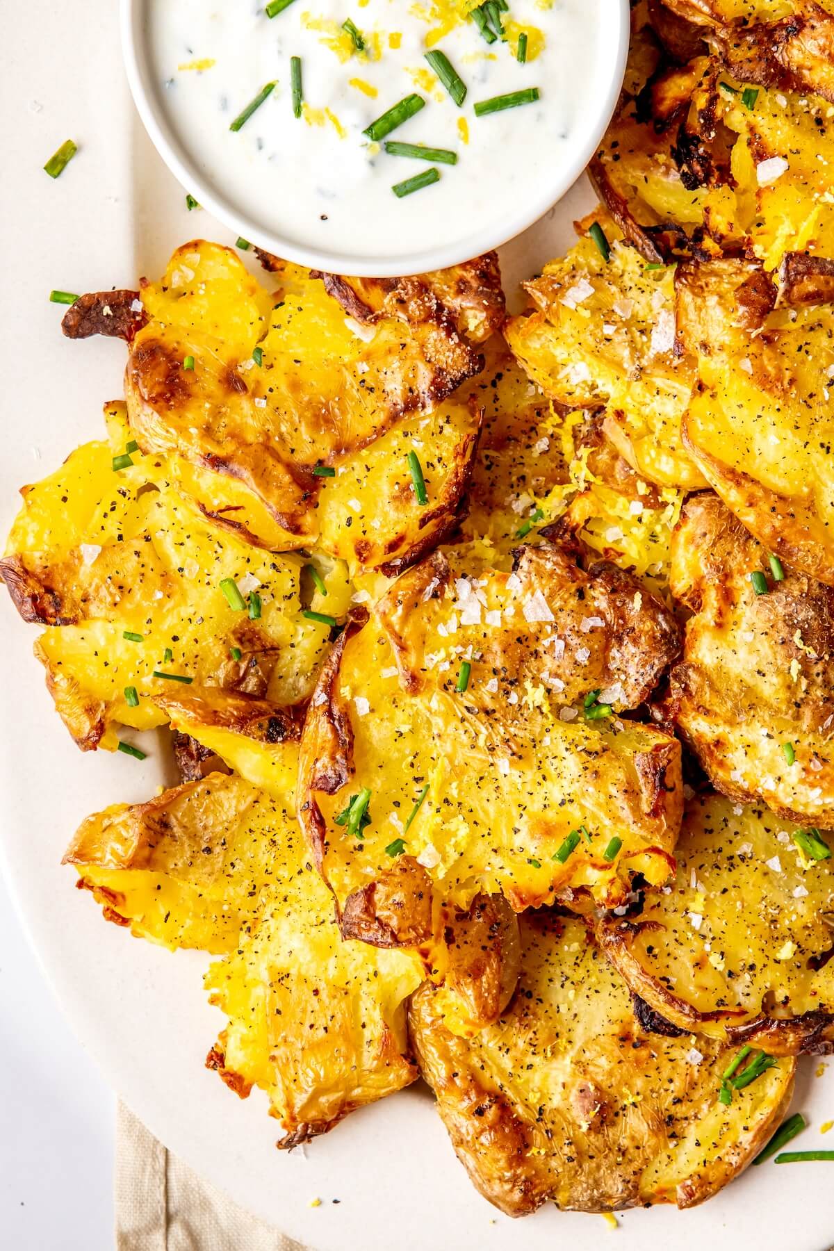 Crispy Smashed Potatoes with Lemony Chive Sauce - Olivia Adriance