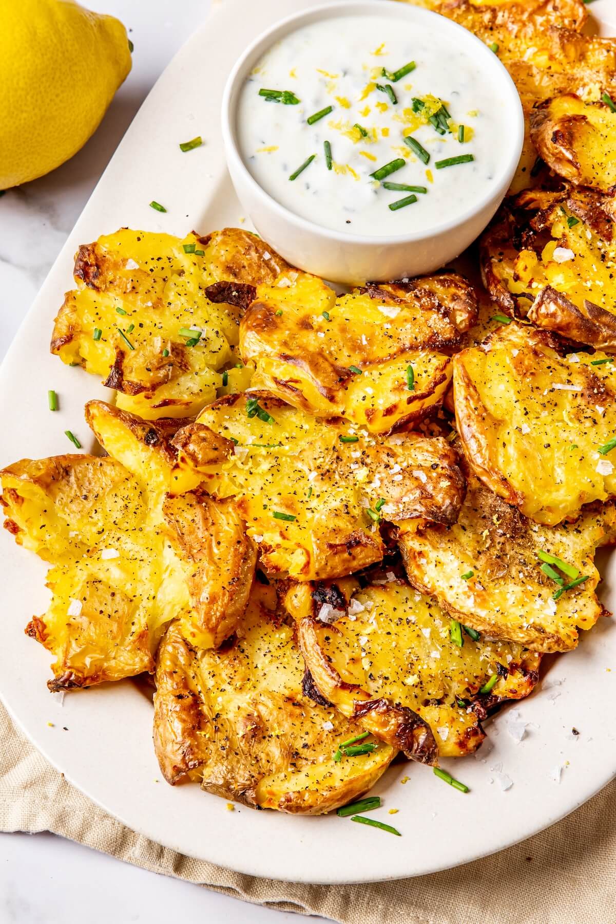 Crispy Smashed Potatoes with Lemony Chive Sauce - Olivia Adriance